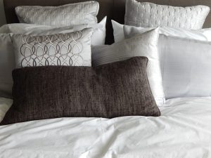 A balance between a bed with white sheets and pillows.