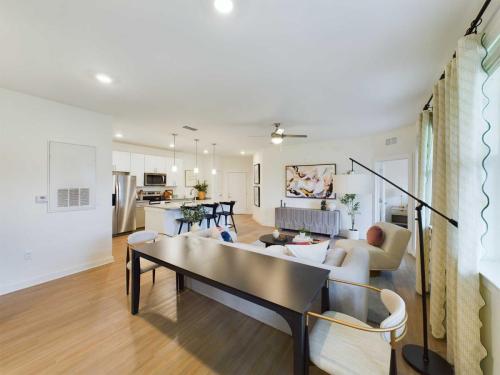 Apartments in Thompson’s Station Open-plan living and dining area with modern furnishings, wooden flooring, and a view of the kitchen. Sanctuary Bluff Apartments in Thompson’s Station