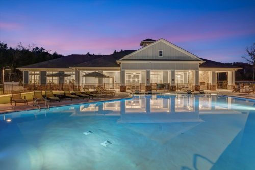 Apartments in Thompson’s Station A large outdoor pool with lounge chairs and umbrellas is in front of a building at dusk, reflecting the soft, colorful sky. Sanctuary Bluff Apartments in Thompson’s Station